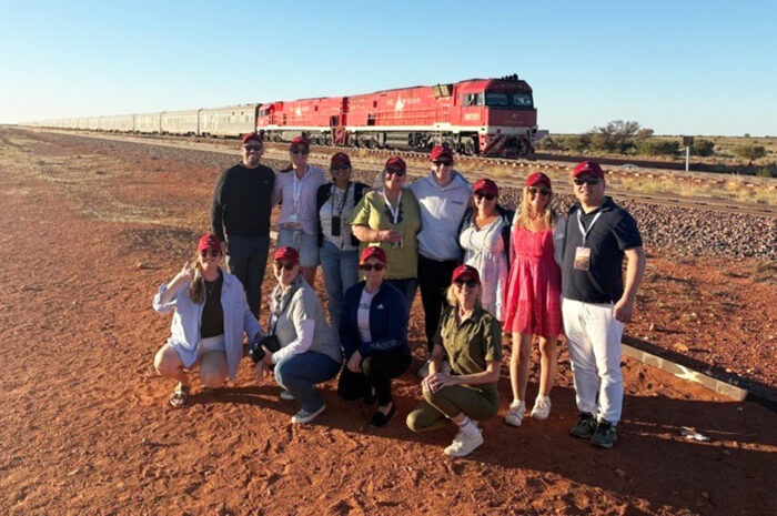 Manguri - Beyonders only Group of people standing on red outback soil in front of a stationary train